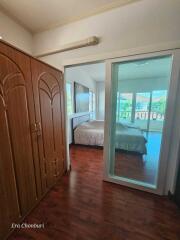 Bedroom with wooden flooring and sliding glass door