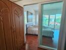 Bedroom with wooden flooring and sliding glass door