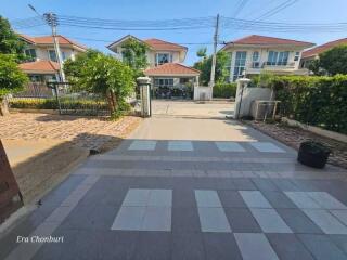 View of a residential driveway with houses in the background