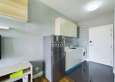 Modern kitchen with sleek appliances and laundry area