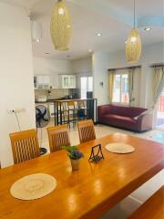 Spacious and well-lit main living space with dining and seating areas