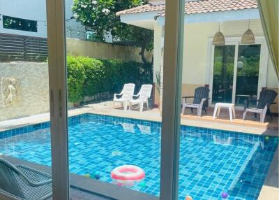 View of a swimming pool area from indoor space