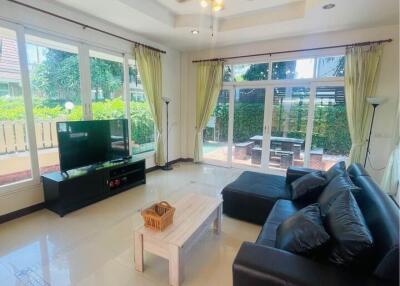 Spacious living room with large windows and garden view