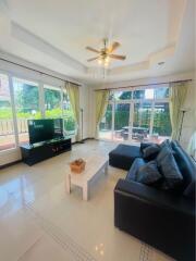 Spacious living room with large windows and garden view