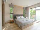 Modern bedroom with large windows and a neatly made bed