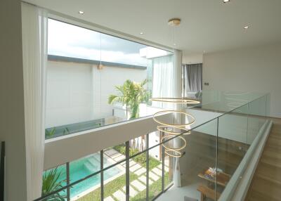 Modern two-story house with glass railing overlooking pool area