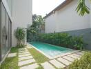 Modern outdoor area with a swimming pool and greenery