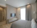 Modern bedroom with contemporary decor, window, and wall-mounted TV