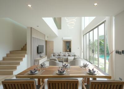 Spacious modern living room with dining area and staircase