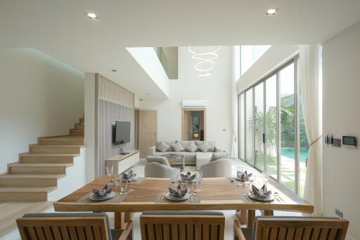 Spacious modern living room with dining area and staircase