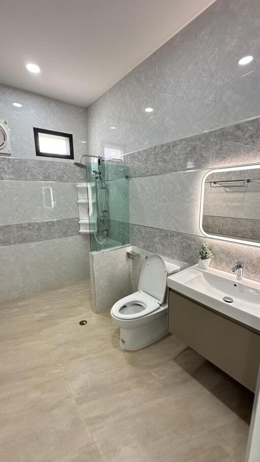 Modern bathroom with glass shower and large mirror