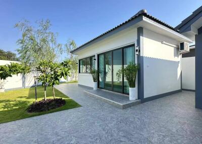 Modern exterior view of a single-story house with a well-maintained lawn