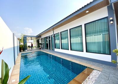 Outdoor pool area with adjacent modern building