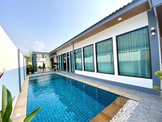 Outdoor pool area with adjacent modern building