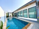 Outdoor pool area with adjacent modern building