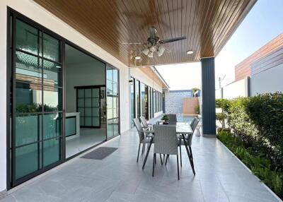 Covered patio with outdoor dining area and ceiling fan