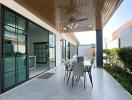 Covered patio with outdoor dining area and ceiling fan