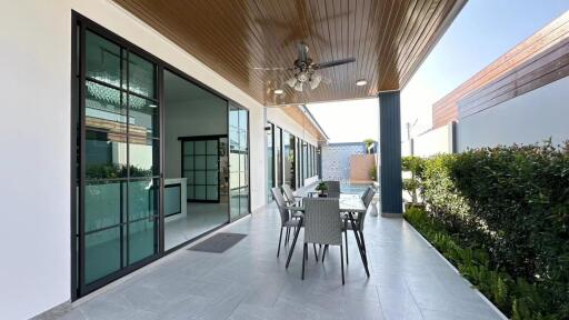 Covered patio with outdoor dining area and ceiling fan