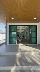 Stylish entrance leading into a modern living room with glass doors