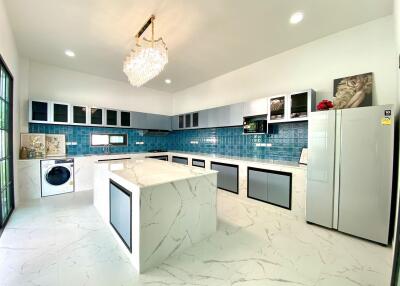 Modern kitchen with island and blue tiled backsplash