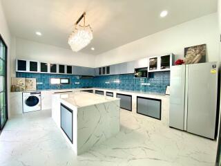 Modern kitchen with island and blue tiled backsplash