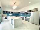 Modern kitchen with island and blue tiled backsplash