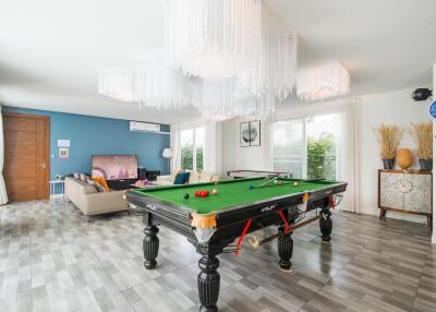 Spacious living area with billiard table and modern décor