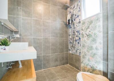 Modern bathroom with tiled walls and shower