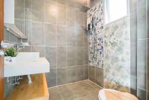 Modern bathroom with tiled walls and shower