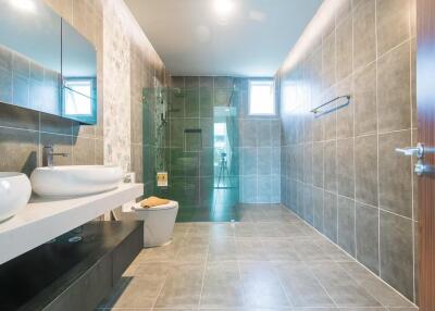Spacious modern bathroom with dual sinks and large walk-in shower