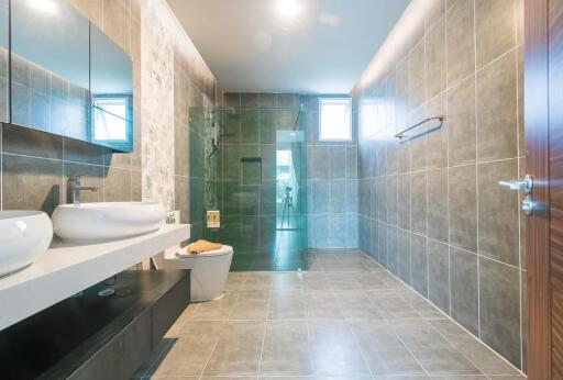 Spacious modern bathroom with dual sinks and large walk-in shower