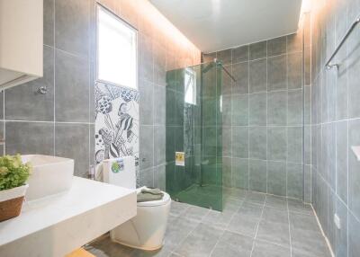 Modern bathroom with glass shower and large tiles