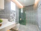 Modern bathroom with glass shower and large tiles