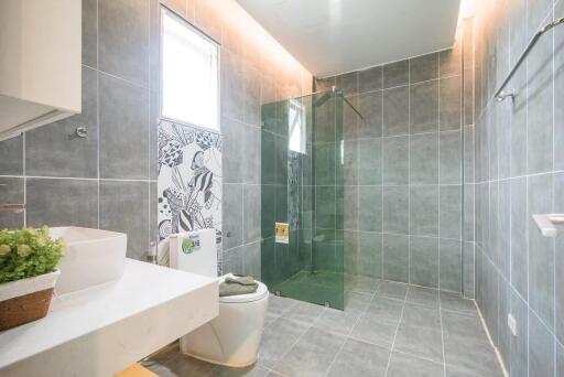 Modern bathroom with glass shower and large tiles