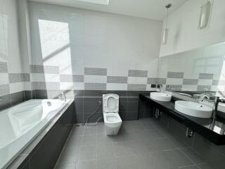 Modern bathroom with bathtub and double sink