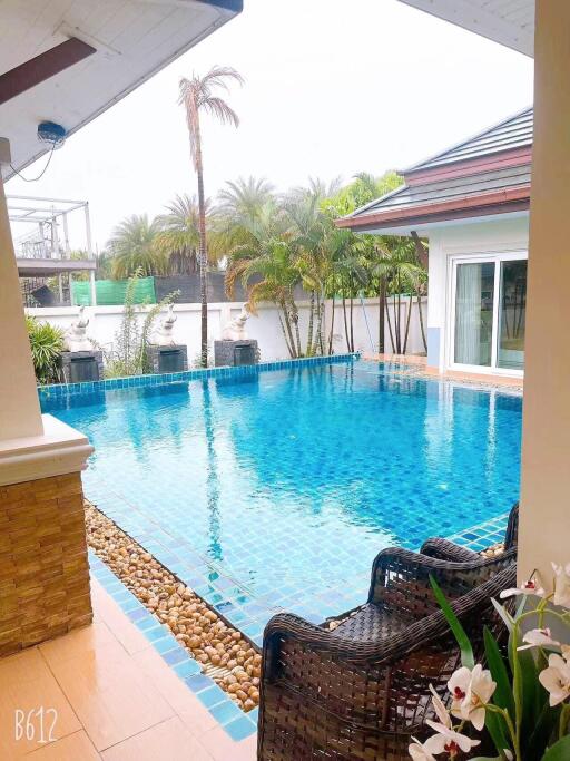 Private outdoor swimming pool with surrounding patio and garden