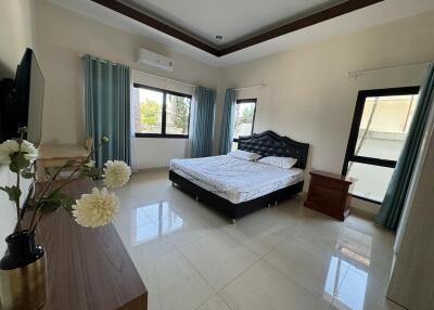 Spacious bedroom with large windows and modern furnishings