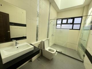 Spacious modern bathroom with shower and sink