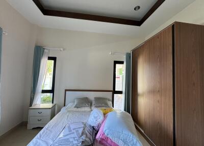 Modern bedroom with large wooden wardrobe and bed