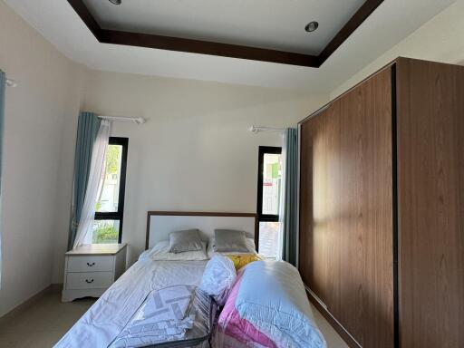 Modern bedroom with large wooden wardrobe and bed