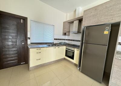 Modern kitchen with stainless steel appliances and light cabinetry