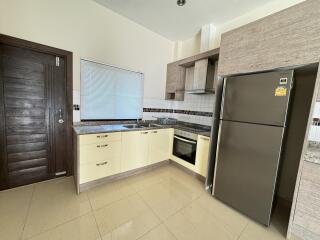 Modern kitchen with stainless steel appliances and light cabinetry