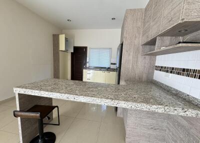 Modern kitchen with granite countertops and wooden cabinets