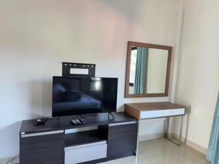 Living room with TV and wall-mounted mirror