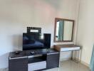 Living room with TV and wall-mounted mirror