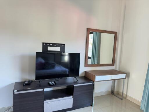 Living room with TV and wall-mounted mirror