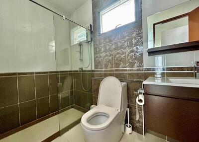 Modern bathroom with glass shower and tiled walls