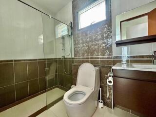 Modern bathroom with glass shower and tiled walls