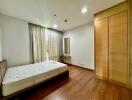 Spacious bedroom with wooden floor and built-in wardrobe