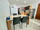 Modern kitchen and dining area with table and chairs